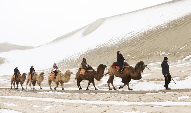 Scenery of snow-covered Crescent spring and Mingsha Mountain